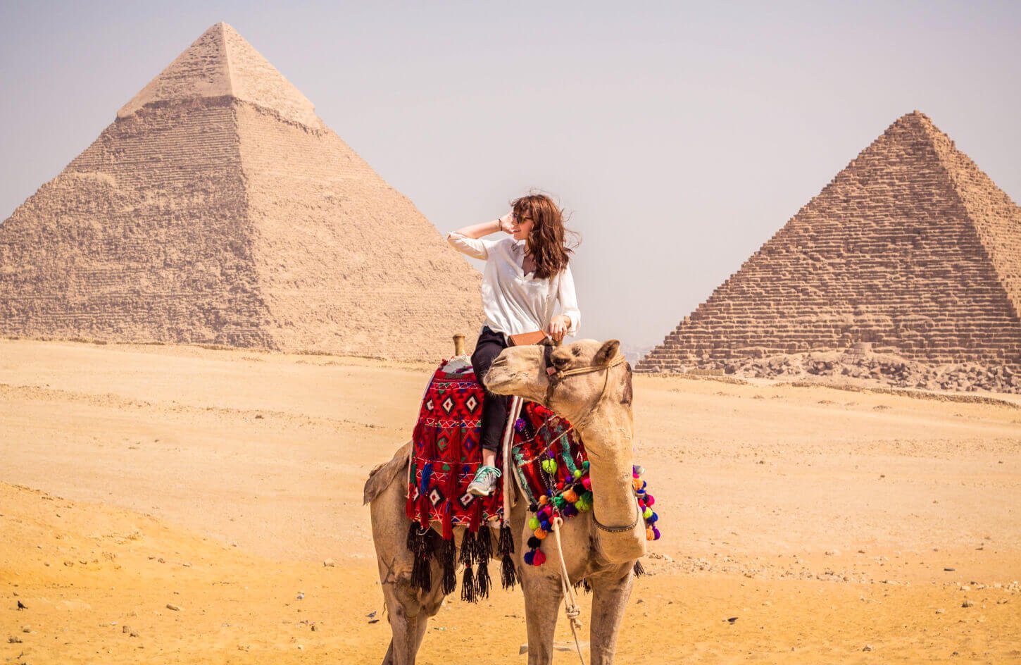 A-tourist-riding-a-camel-in-front-of-the-pyramids